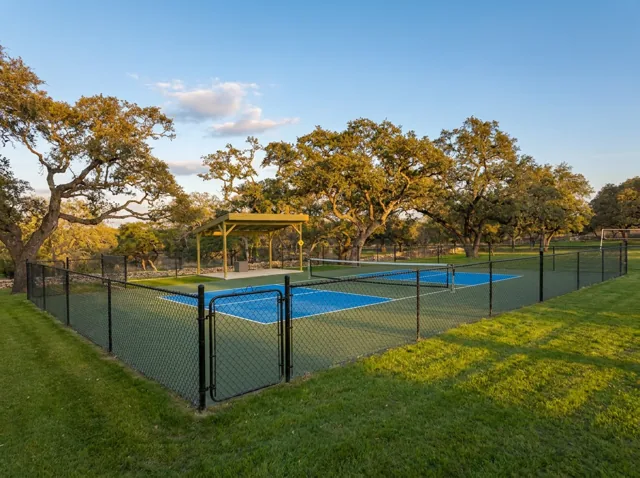 The pickleball courts under the oaks at golden hour